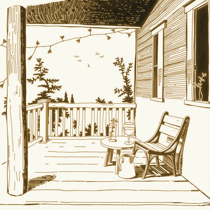 A pitcher of lemonade and two glasses on a small table on a shaded wooden porch