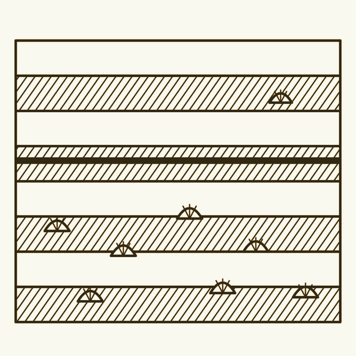 A cliff of rock layers with a thin dark band, fossils plentiful below it and few above