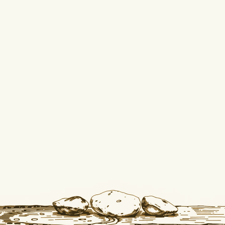 Three smooth river stones of increasing size laid in a row on a plain wooden table, white background