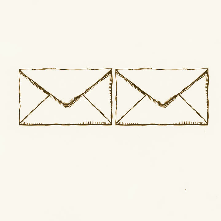 Two identical sealed envelopes lying side by side, plain background, nothing else, no border