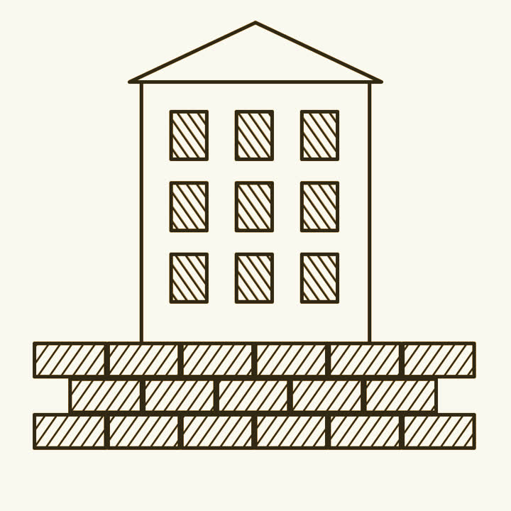 A tall building resting on neat layers of foundation blocks