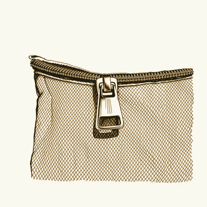 A close view of a brass zip fastener half open on a canvas bag, plain background, nothing else, no border