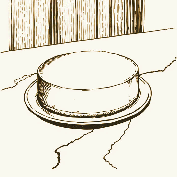 A whole cheesecake on a plate on a marble counter