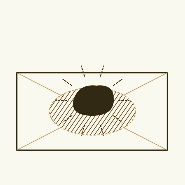 A dark lump of ore resting on a wrapped photographic plate, with a fogged patch showing beneath it