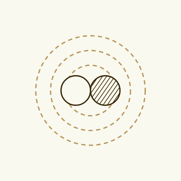 Two small spheres, one plain and one shaded, meeting in rings of energy