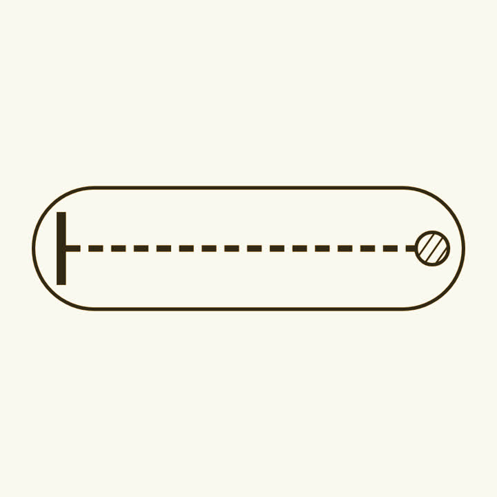A long glass tube with a disc at one end and a glowing patch at the far end
